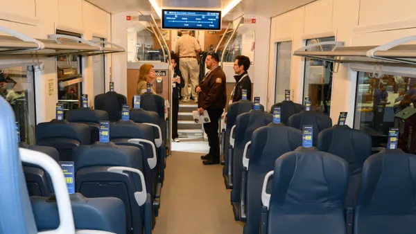 People standing in a train car.