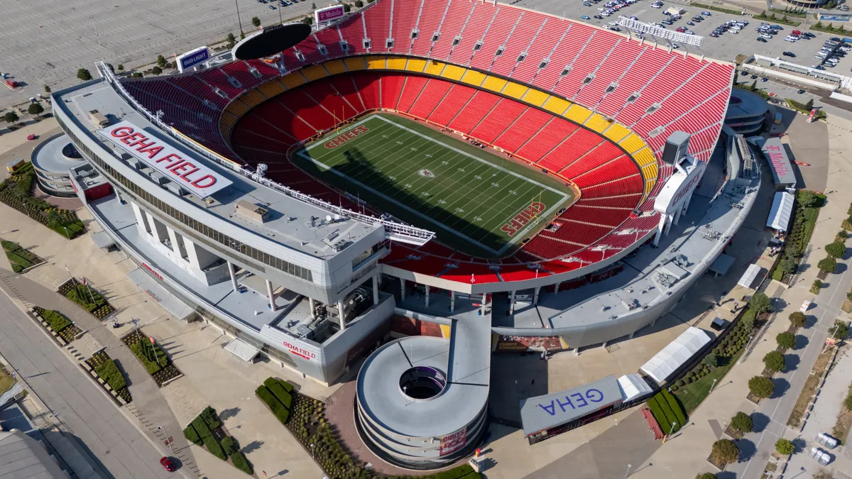 An aerial shot of a large stadium with a football field in the center.