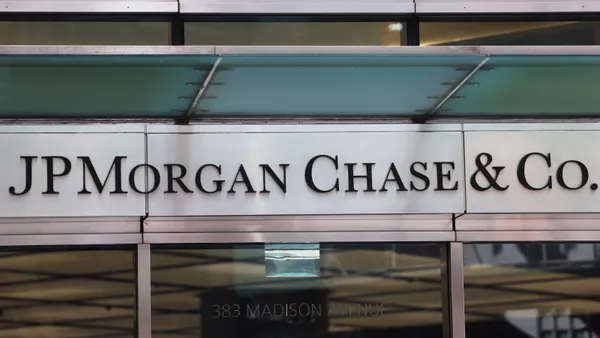A logo reading "JPMorgan Chase & Co." hangs over a set of doors
