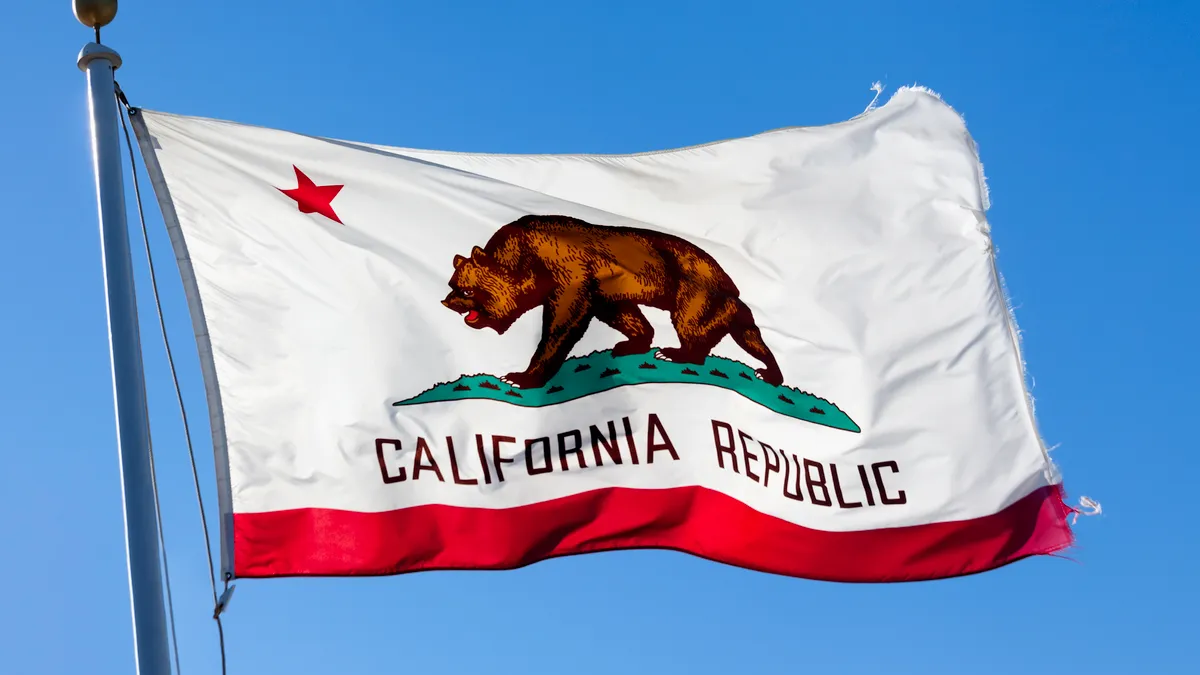 The California state flag waves in the wind.