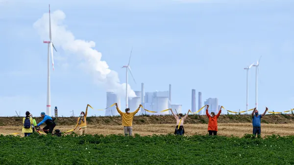 People seen protesting in front of a factory.