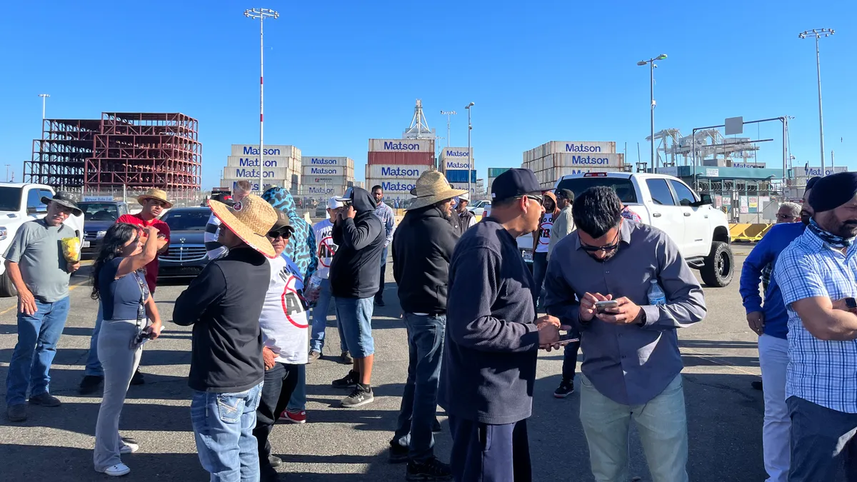 A group of truckers at the Port of Oakland wait for a response from port directors.