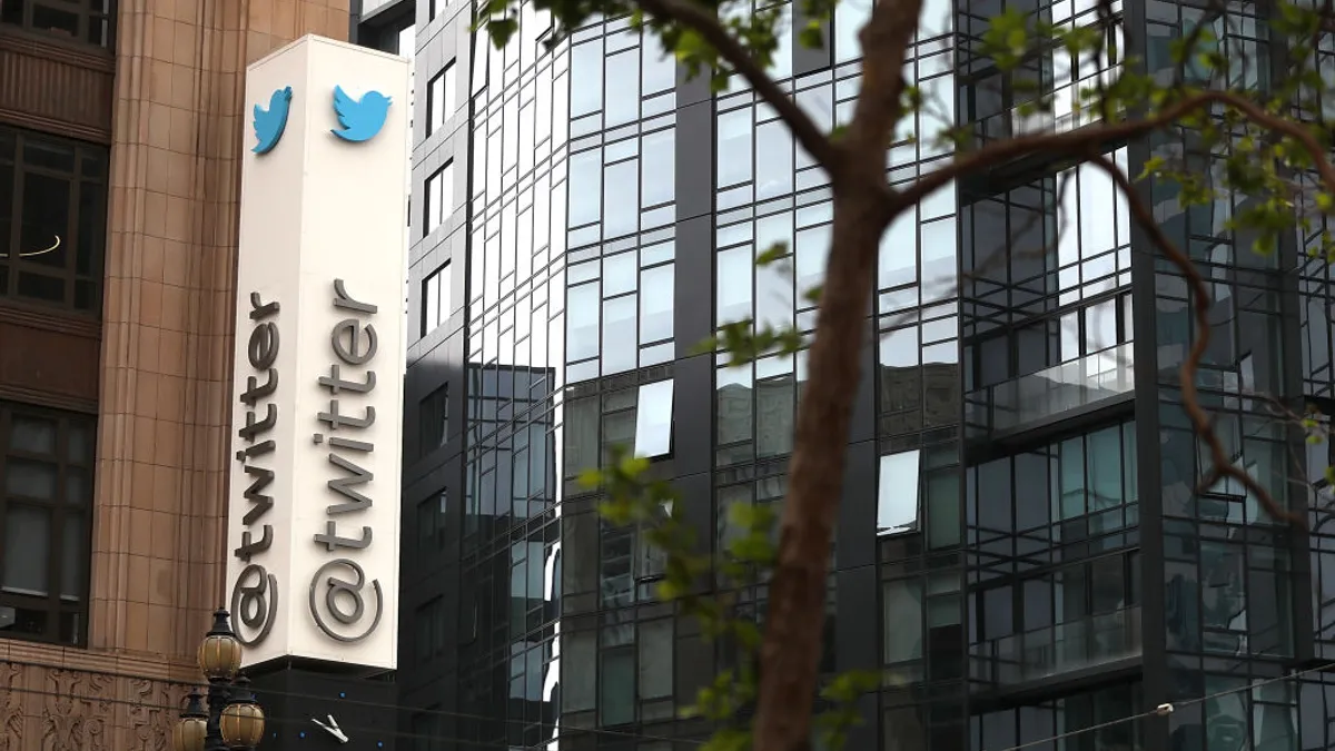 A sign on a building reading "Twitter", with another glass-walled building in the background.