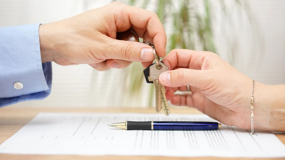 Hands holding house keys