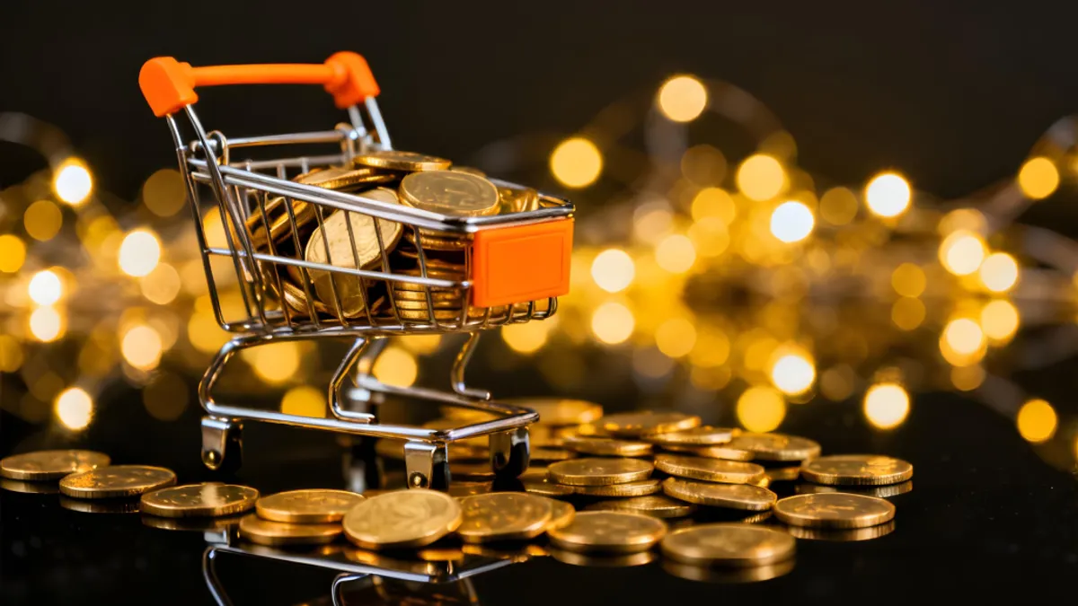 Mini shopping cart filled with gold coins on a reflective surface