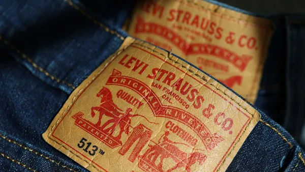 back patch on a pair of blue jeans in red lettering