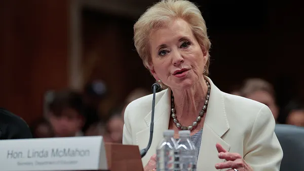 Linda McMahon speaks while seated at a podium.