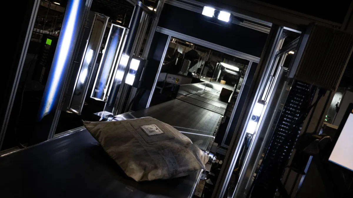 A system scans package labels before routing them to their correct chute in the UPS Centennial Ground Hub on Dec. 6, 2021 in Louisville, Kentucky.