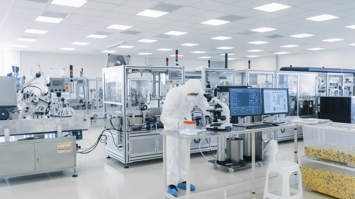 A technician works in a pharmaceutical manufacturing laboratory.