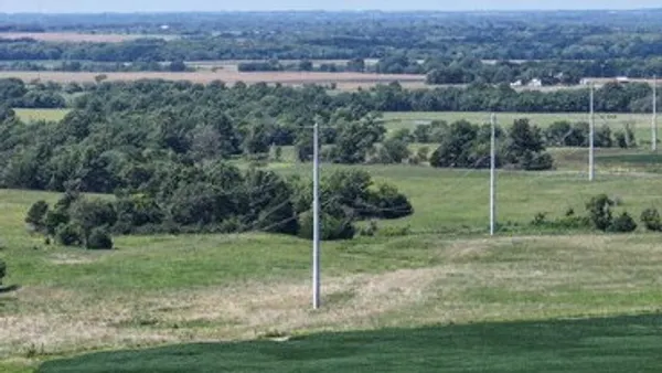 An electric transmission line crosses a field.