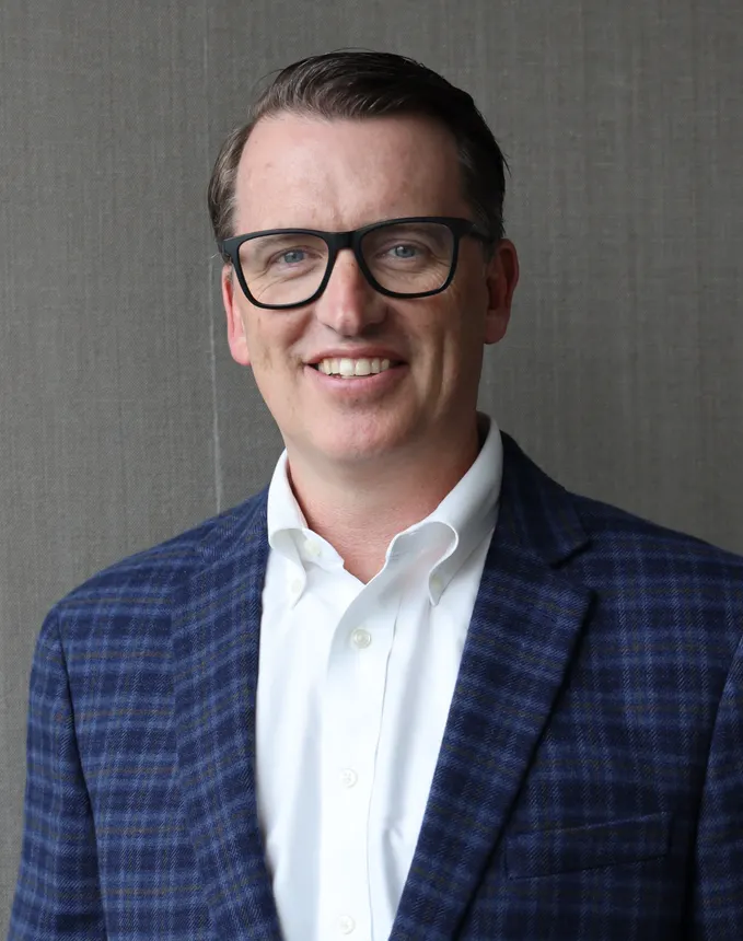 Headshot of a man in professional attire.