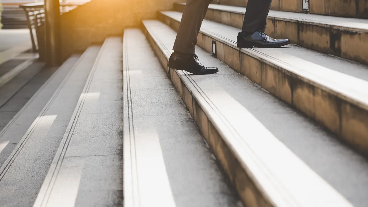 Businessman climbing set of stairs