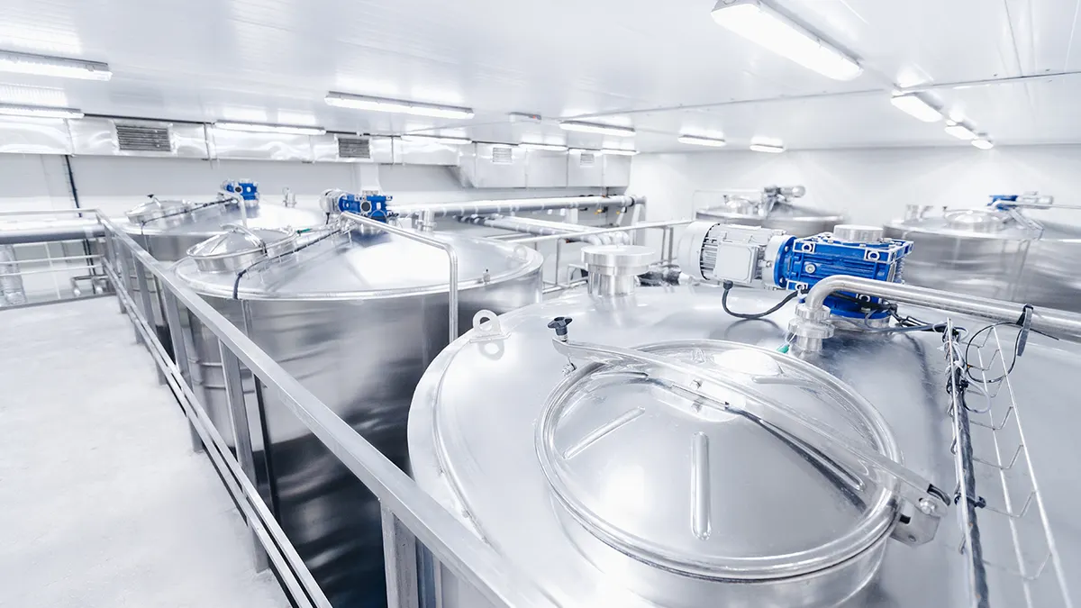 Equipment dairy plant, milk factory industry. Stainless steel storage and processing tanks.