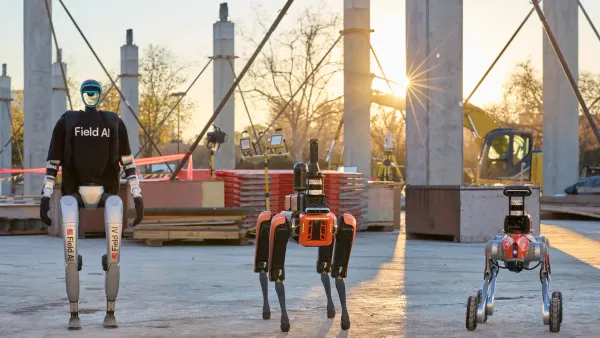 A trio of robots stand on a construction jobsite, with under-construction materials in the background. One robot is bipedal, one is quadripedal, and one is on wheels.