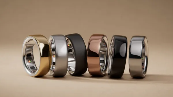 A picture of five Ōura smart rings against a gold background.