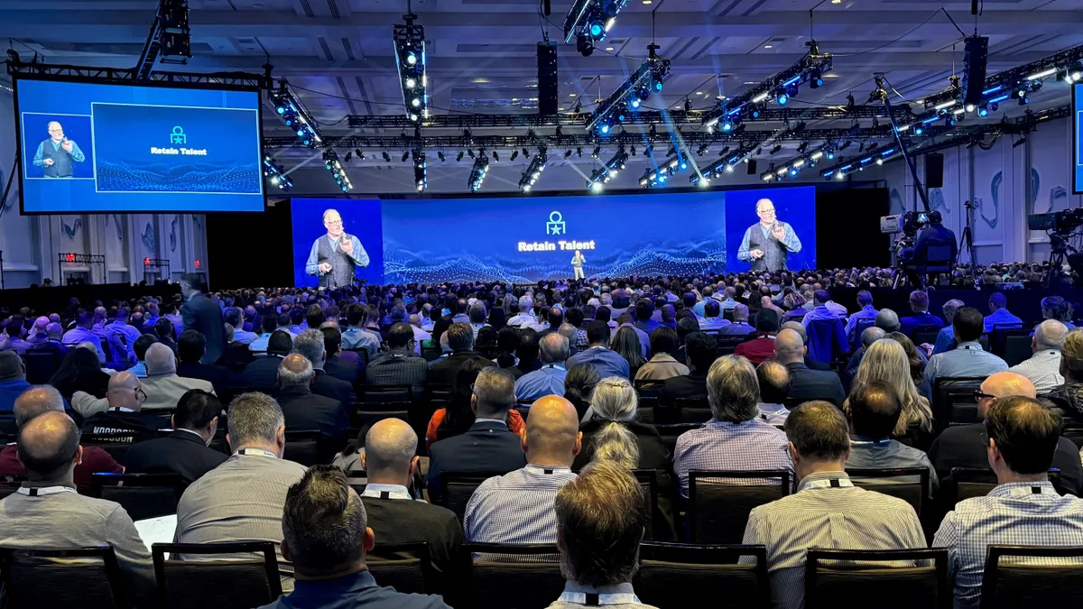 Chris Howard speaks on a large conference stage