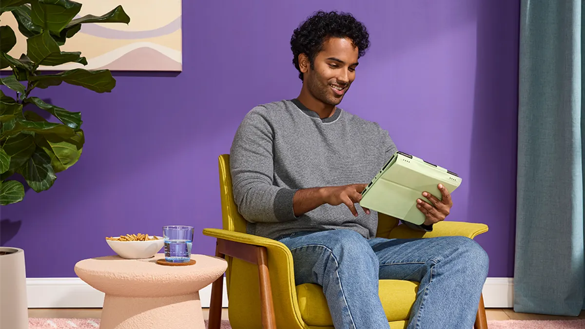 Young man sitting on sofa using a digital tablet