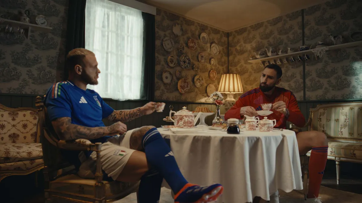 Two soccer players drink tea