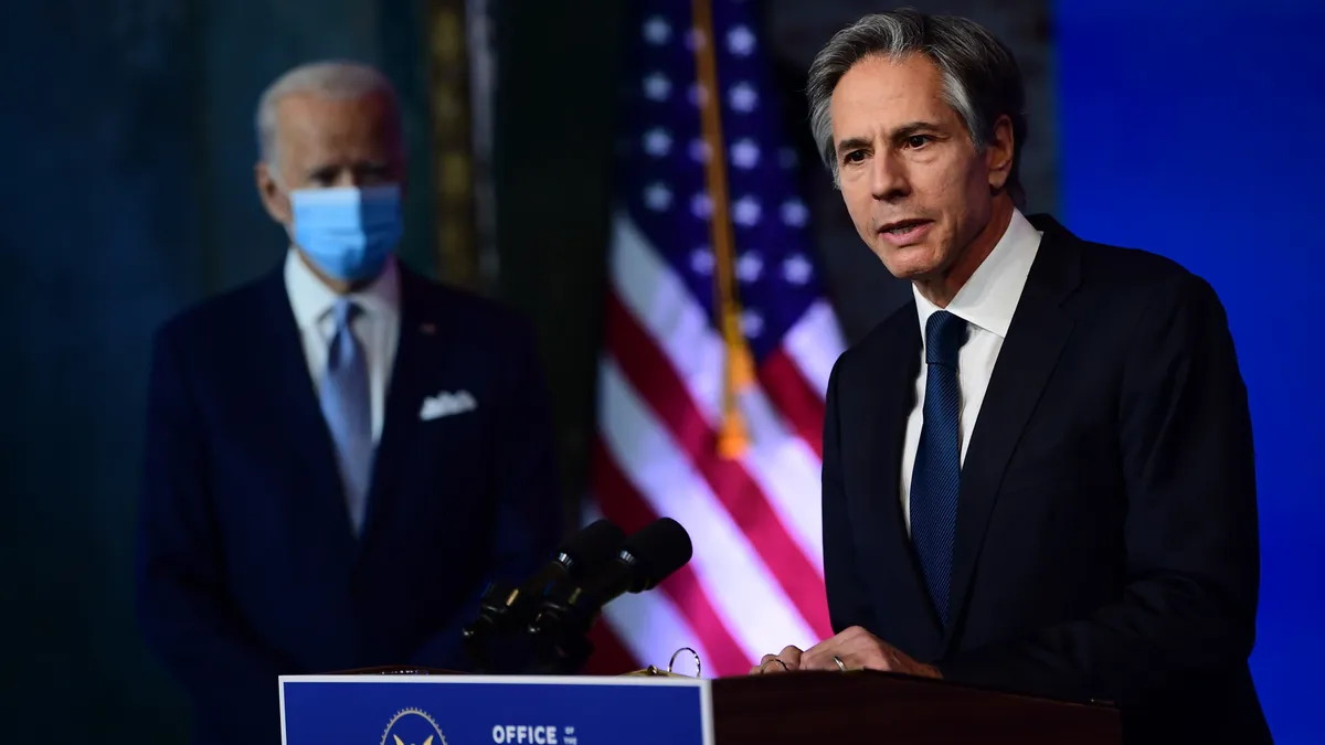 Secretary of State Antony Blinken speaks alongside President Joe Biden.