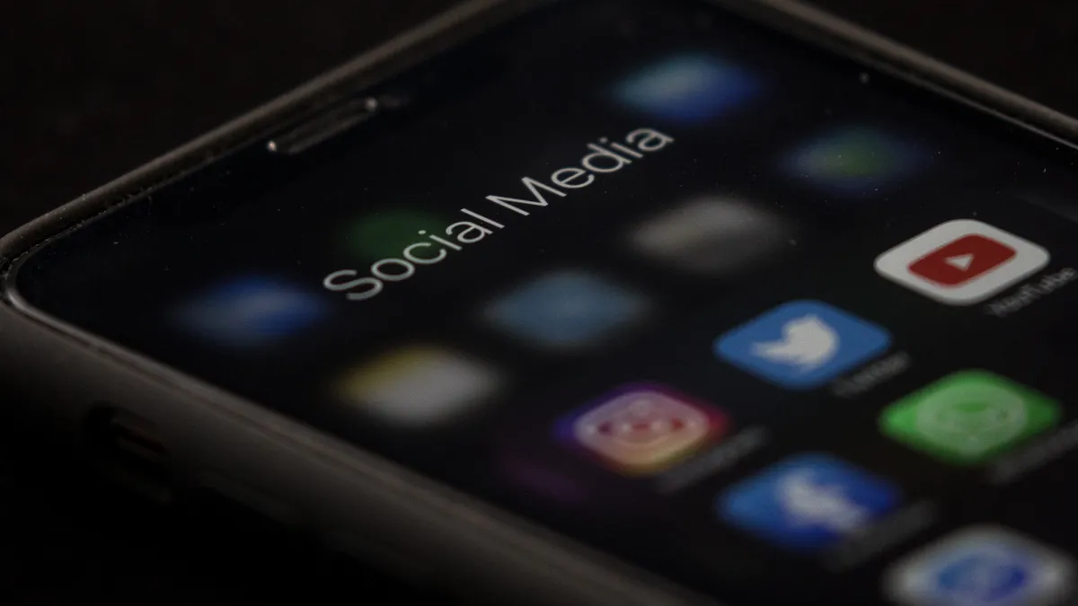 A photo of a phone showing several social media app logos.