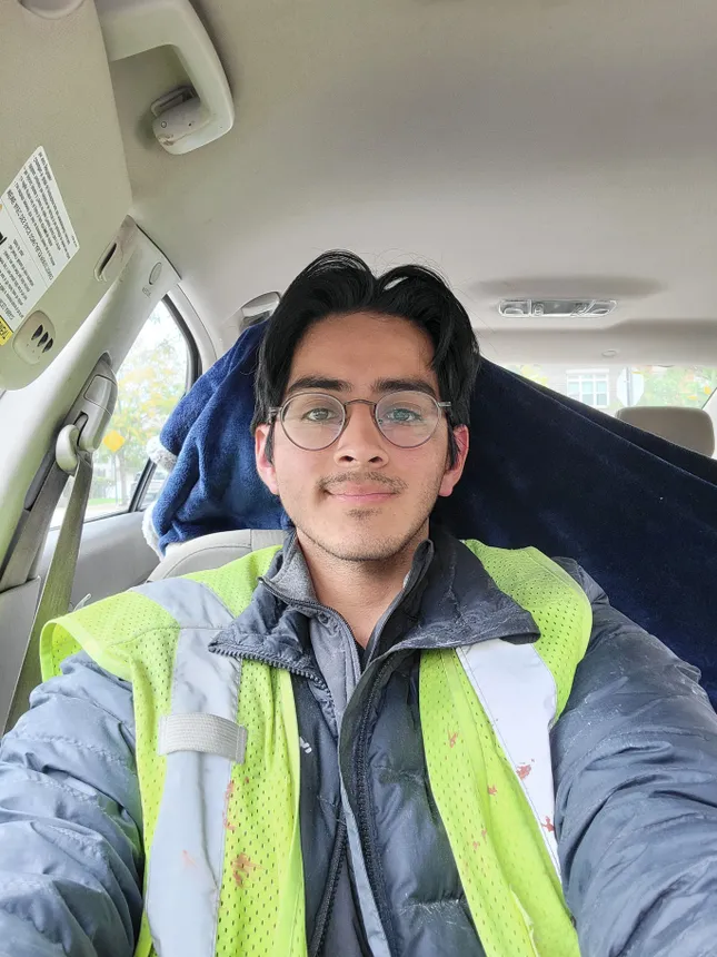 A selfie of an electrician sitting in a vehicle.