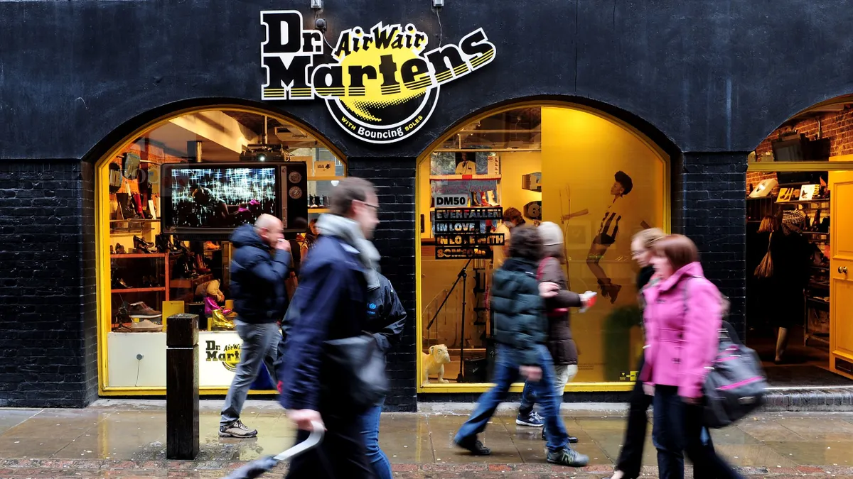 A view of a Dr. Martens store as people pass by.