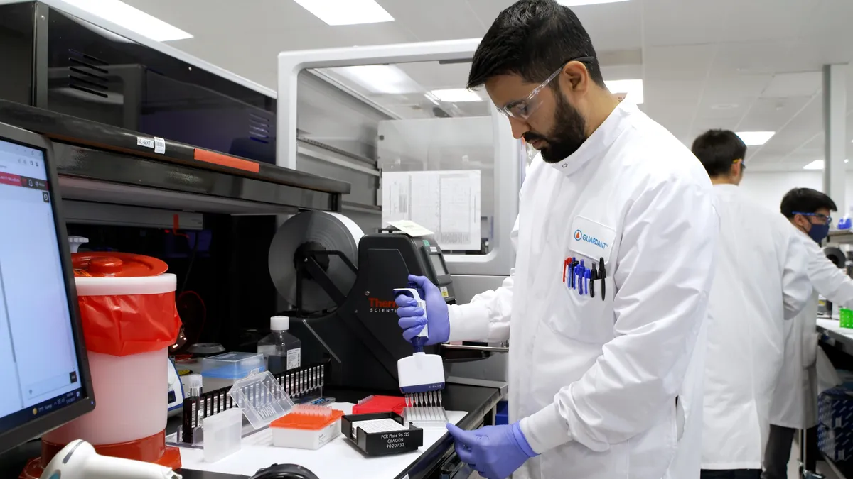 A lab technician runs Guardant Health's Shield blood test for colorectal cancer screening in a lab.