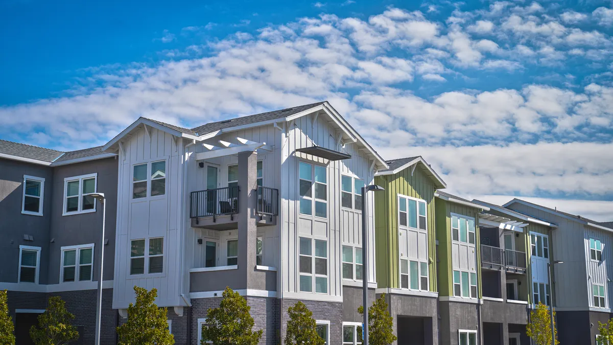 Angle view of an apartment building with a cloudy sky.