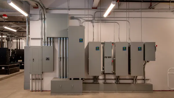 Electric boxes and wiring on a wall.