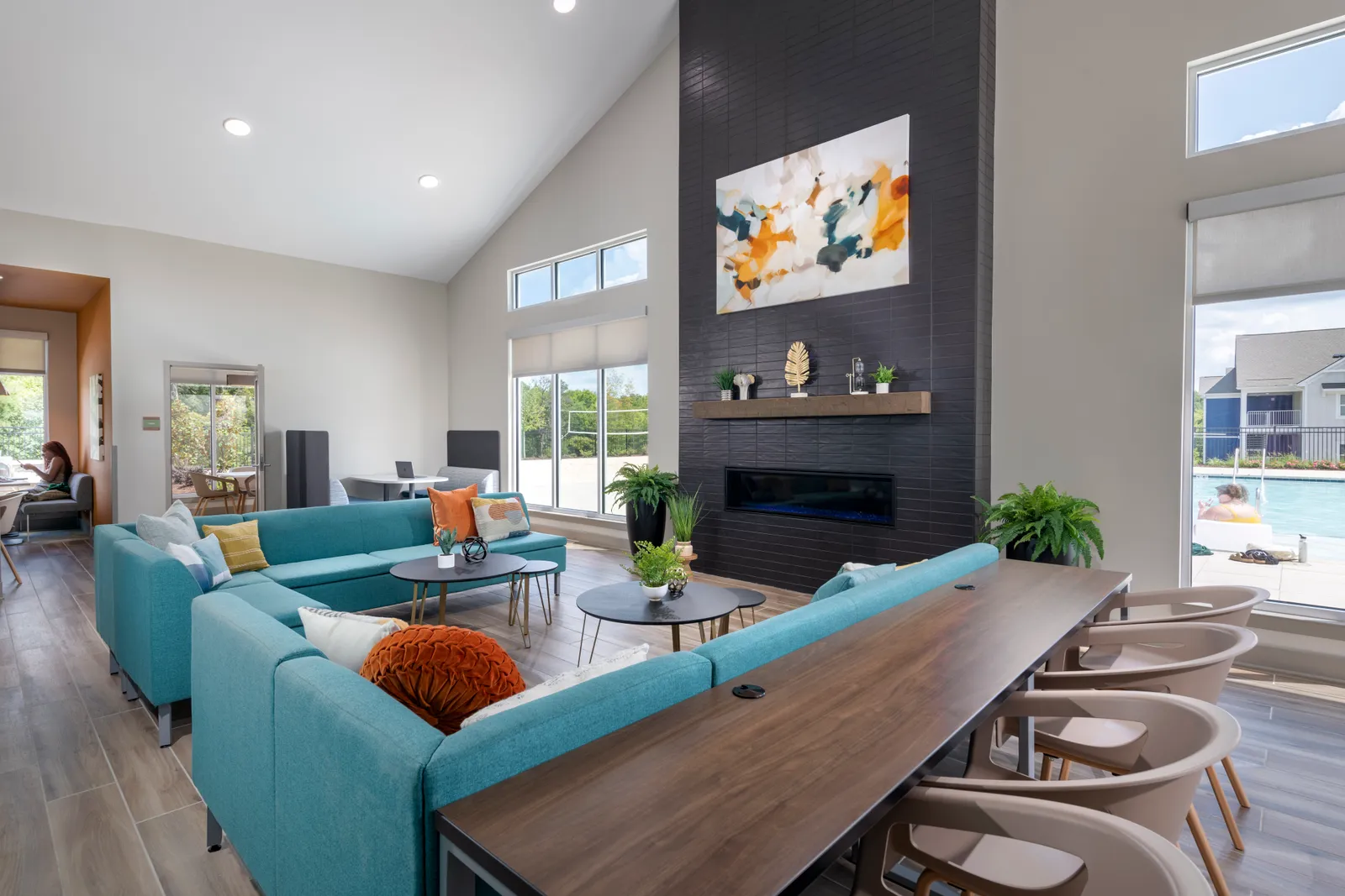 A lounge space in an apartment building with green couches.