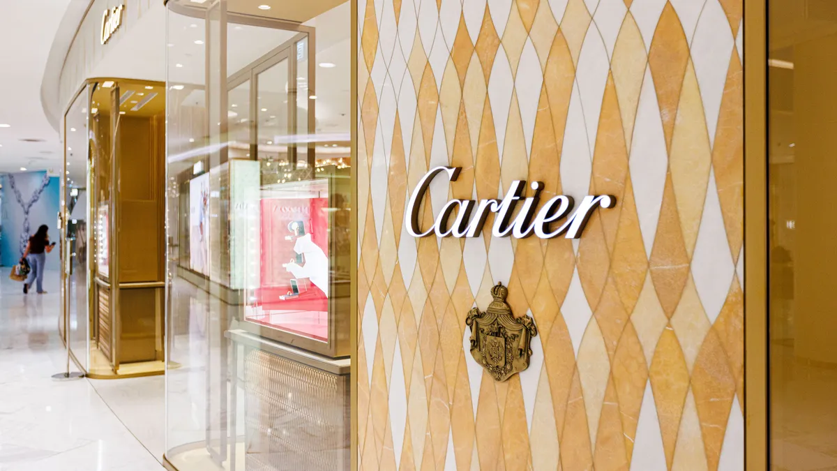 A Cartier store with a visible logo is seen in an indoor mall.