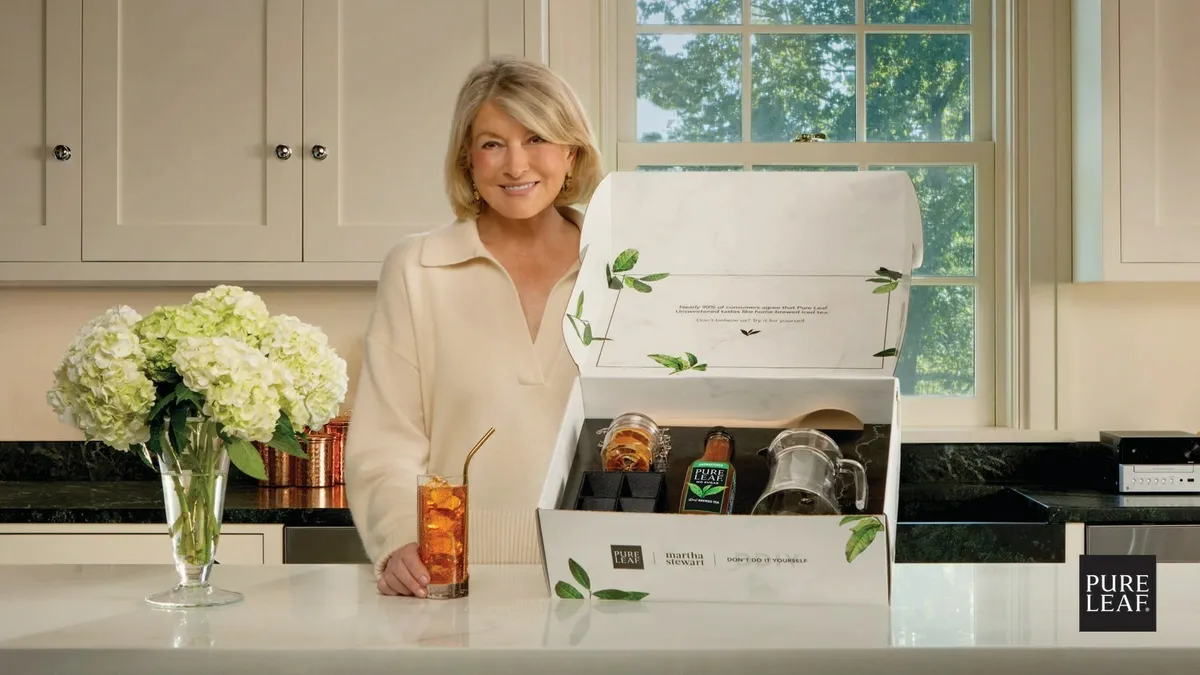 Martha Stewart stands behind a counter with the Pure Leaf iced tea kit.