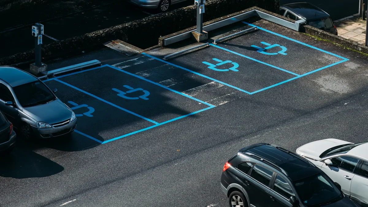 EV charging spots are outlined in a commercial facilities' parking lot.