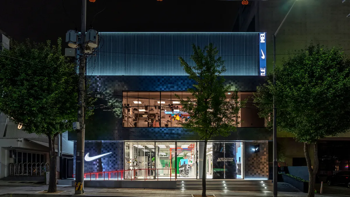 An illuminated Nike Style store in Seoul, South Korea, at night.