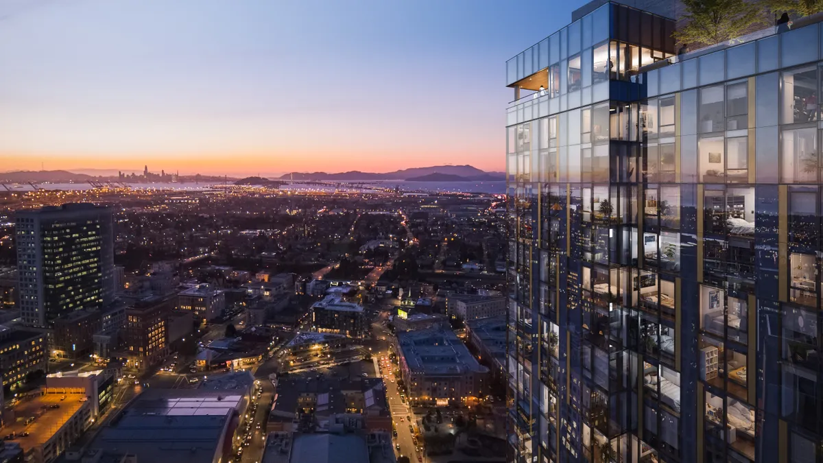 A sunset view of a tall glass skyscraper.