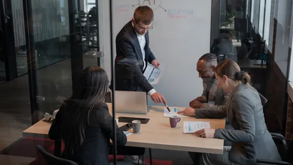 Business team in a modern office discussing data analytics and artificial intelligence.