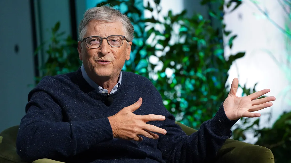 Bill Gates speaks onstage at a summit.