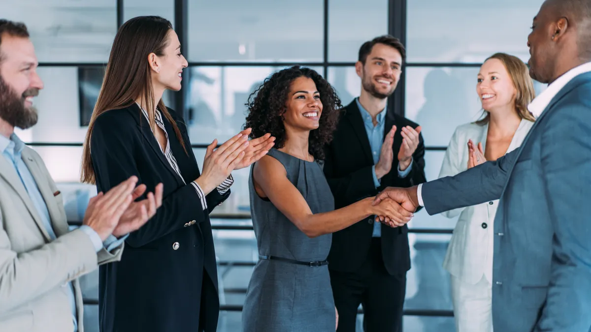 Business people greet a new hire