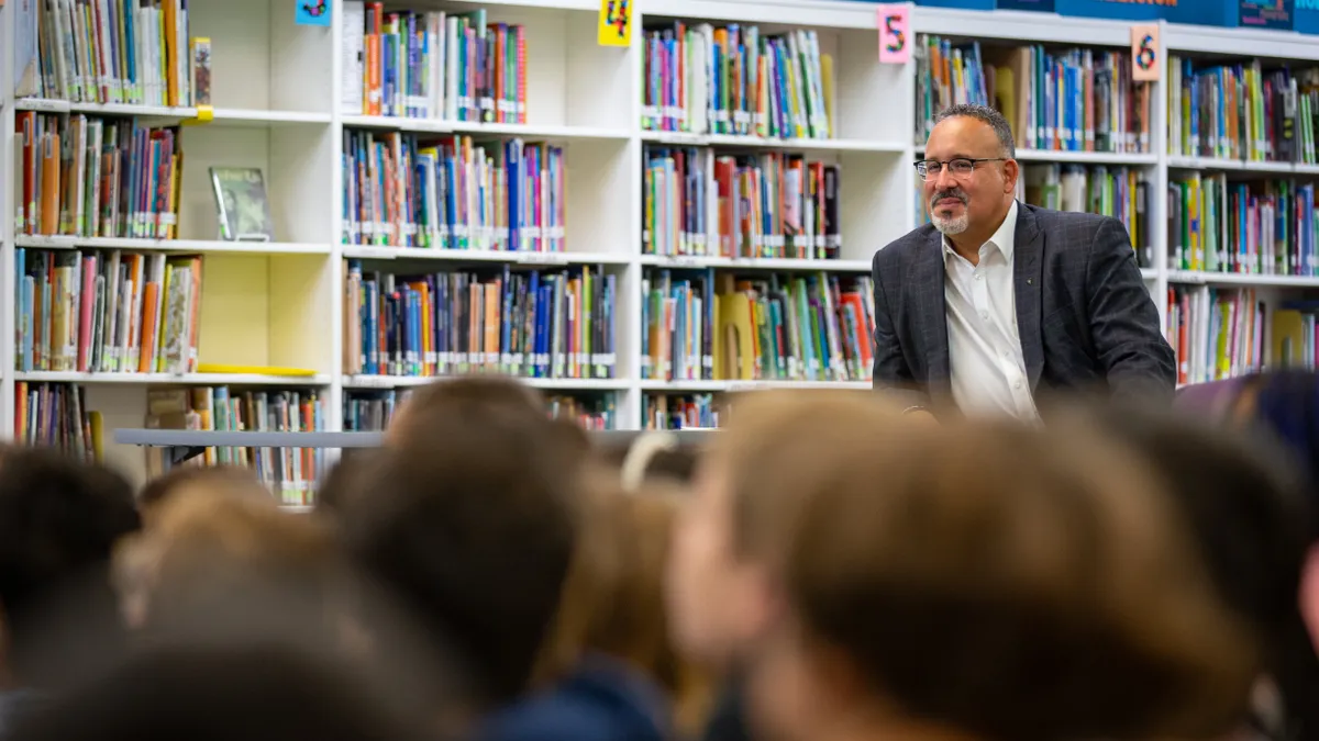 U.S. Secretary of Education Miguel Cardona sits in front of an elementary school class in West Virginia