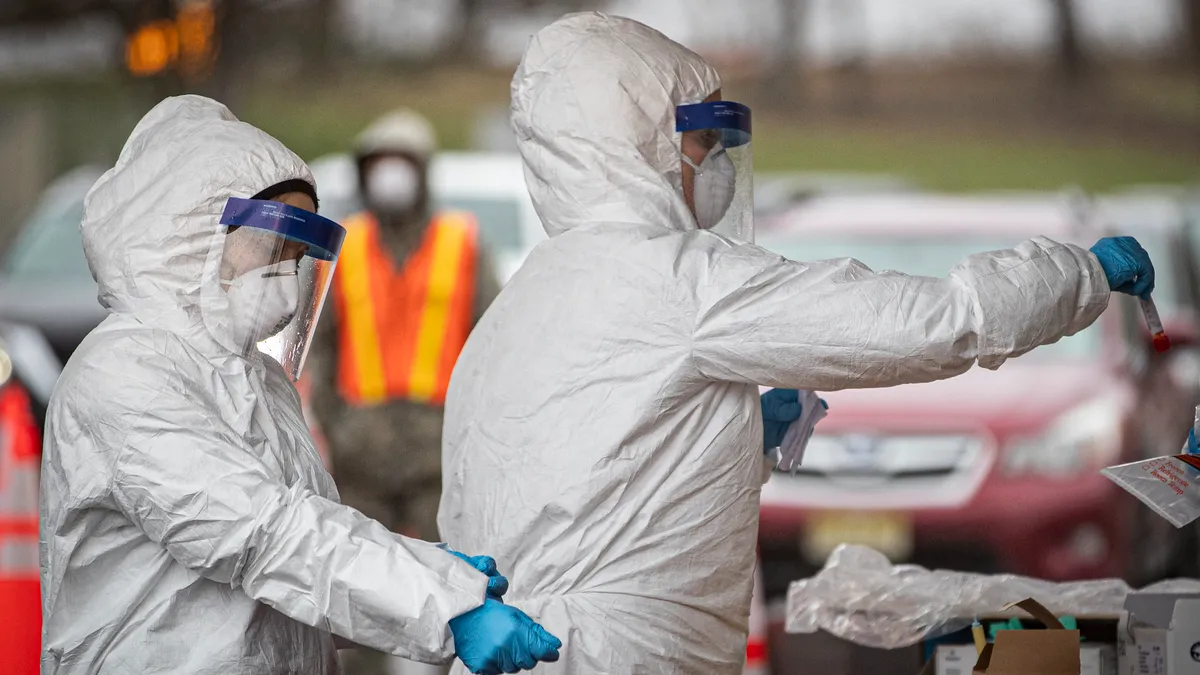 New Jersey Air National Guard medics with the 108th Wing process specimens at a COVID-19 Community-Based Testing Site at the PNC Bank Arts Center in Holmdel, N.J., March 23, 2020. The testing site, es