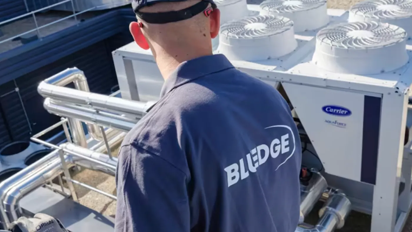 A technician works on a Carrier HVAC system.
