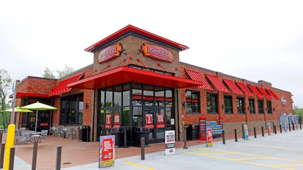 A photo of the exterior of a convenience store. A Sign over the door says Sheetz.