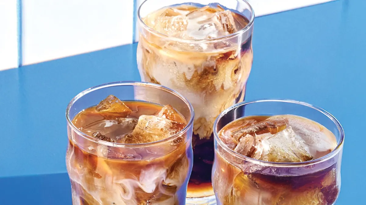 An image of three iced coffees with a sky blue background