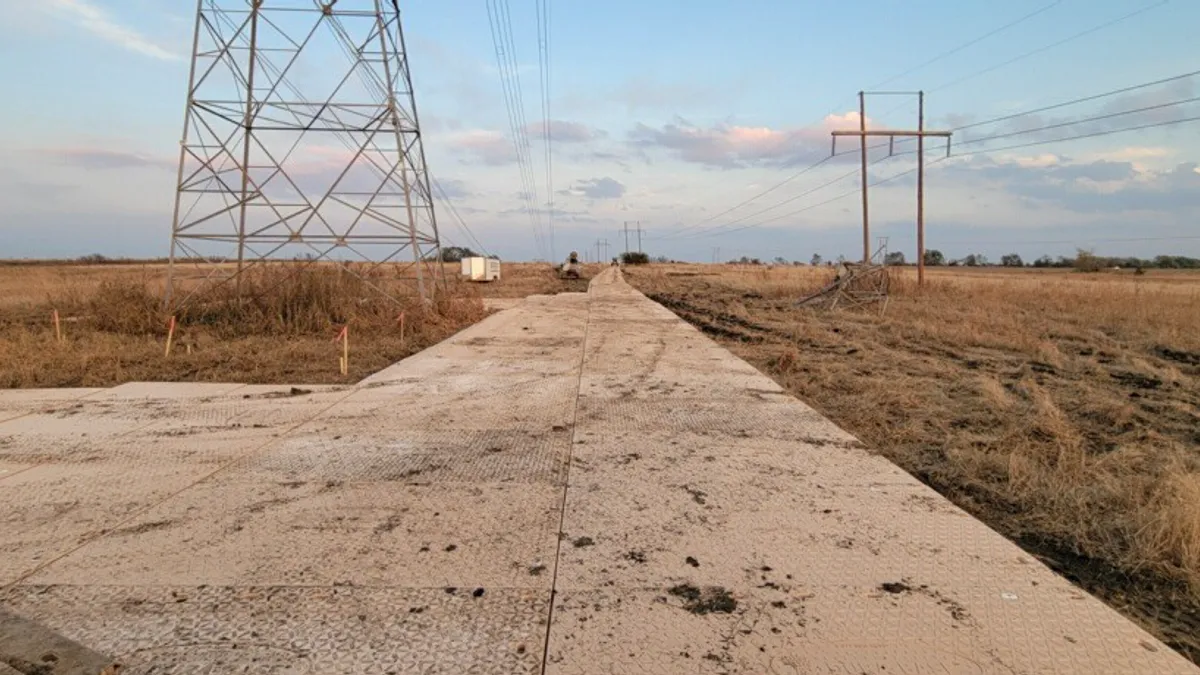 Open land with electric tower.