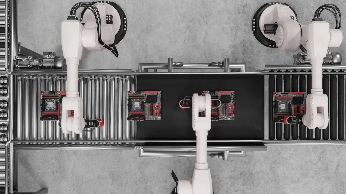 Overhead view of white robotic arms on an assembly line