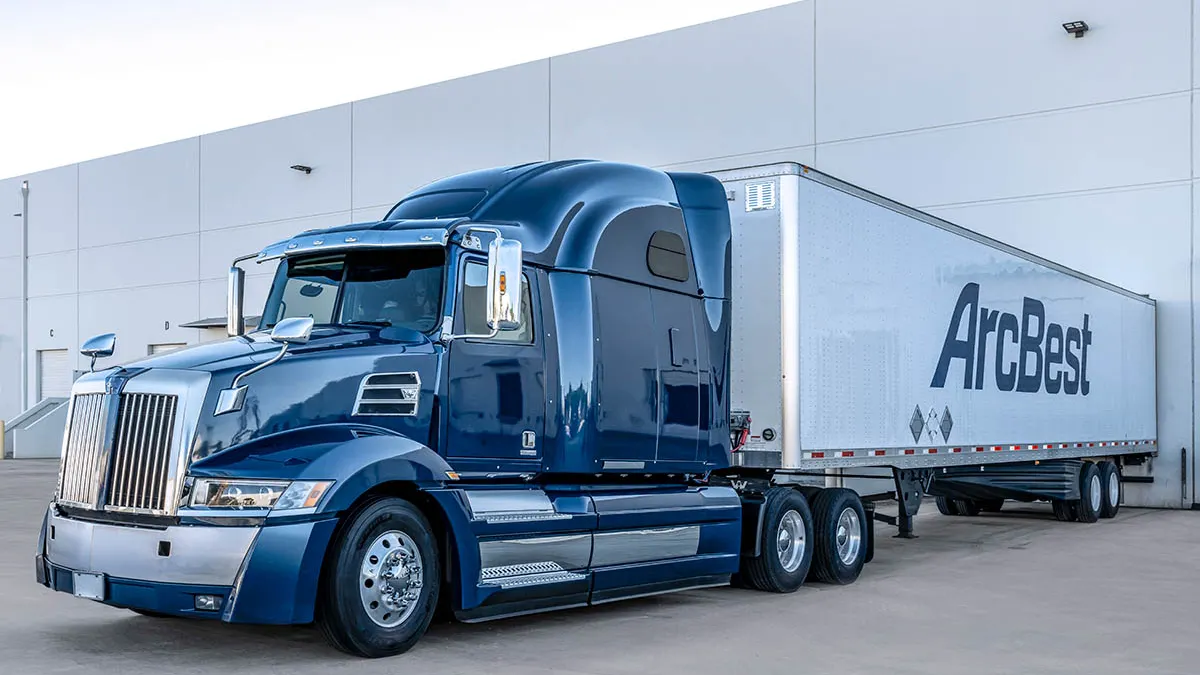 A freight truck outside a warehouse.