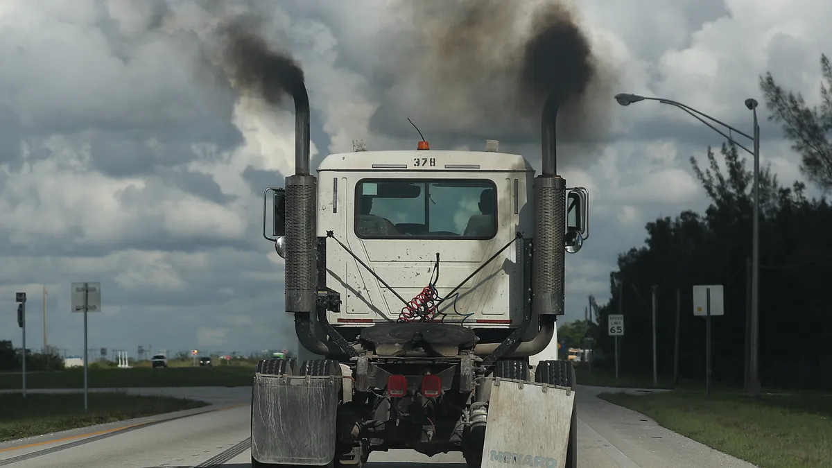 Smoke pours from the exhaust pipes of a truck on November 5, 2019 in Miami, Florida.