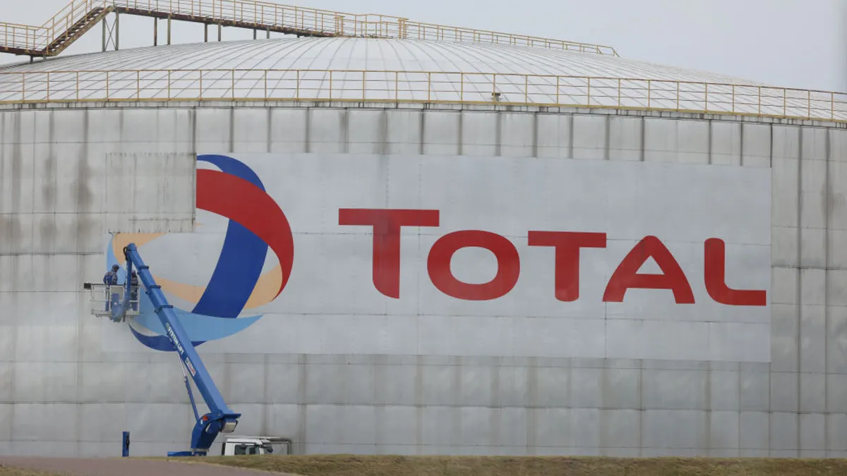 An oil storage tank seen with the TotalEnergies logo.