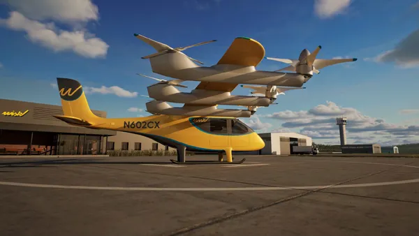 Futuristic yellow aircraft  with multiple propellers on the ground in front of a commercial building.