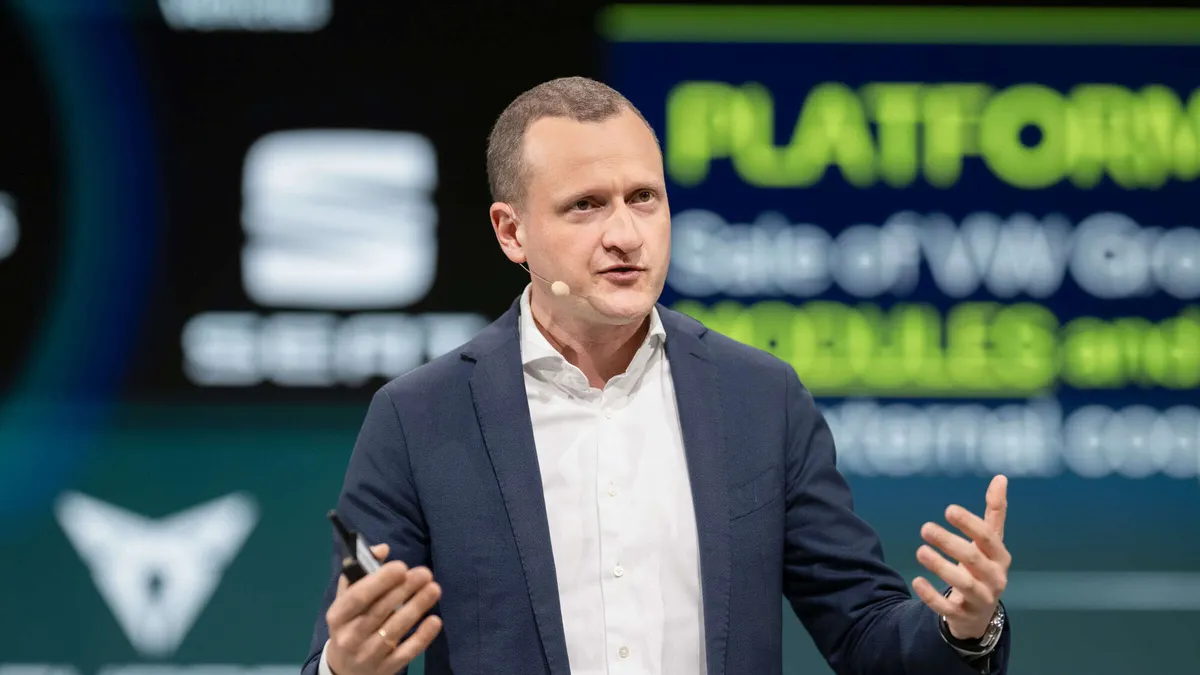 Ludwig Fazel speaking at a Volkswagen presentation.
